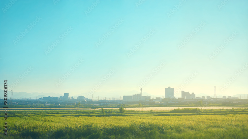 Distant city skyline at sunrise, Contrast of modern urban development and rural countryside in morning light landscape and fields Distant city skyline at sunrise, Contrast of modern urban development and rural countryside in morning light landscape and fields