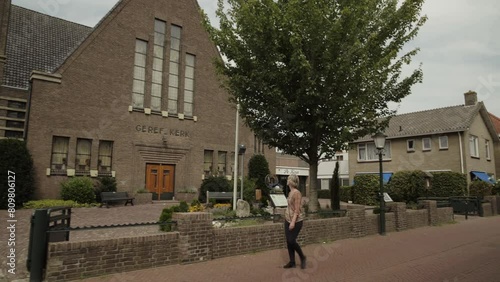 Wallpaper Mural Woman walks past a church in a small town Torontodigital.ca