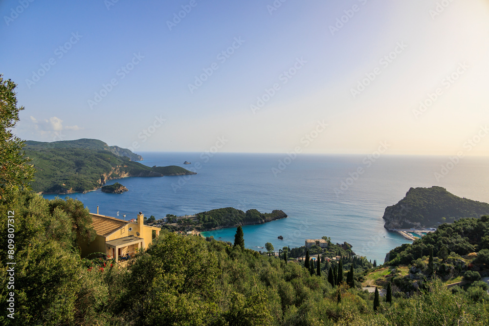 View in the evening under a blue sky over the bay and the sea at Paleokastrtitsa on the island of Corfu