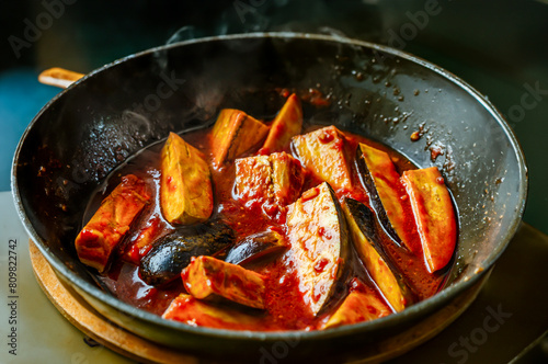 eggplants in tomato sauce cooked in frying pan photo