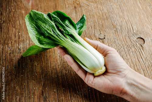 man with a bok choy in his hand
