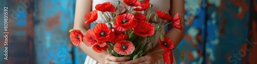Vivid red poppies held in tender woman hands © dashtik