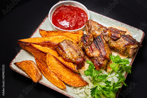 Grilled pork ribs with baked potatoes