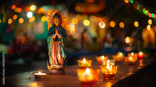 Statue of the virgin mary surrounded by lit candles photo