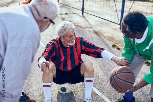 Senior men playing sports and chatting on outdoor court