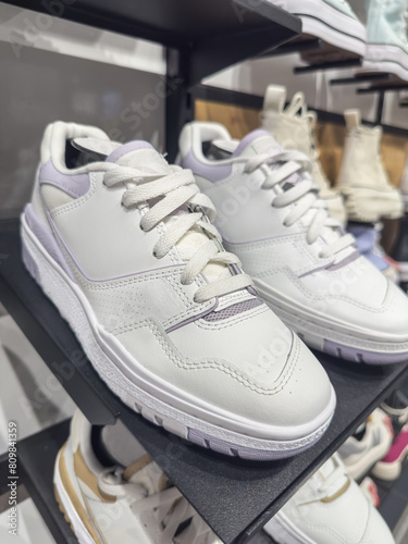 Male or female sneakers shoes displayed on shelves for sale in mall © Svitlana