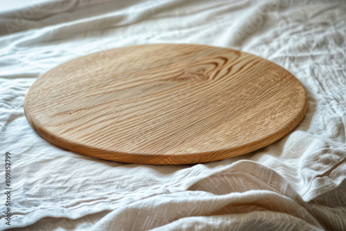 Circular Wooden Cutting Board on a Textured White Fabric Background