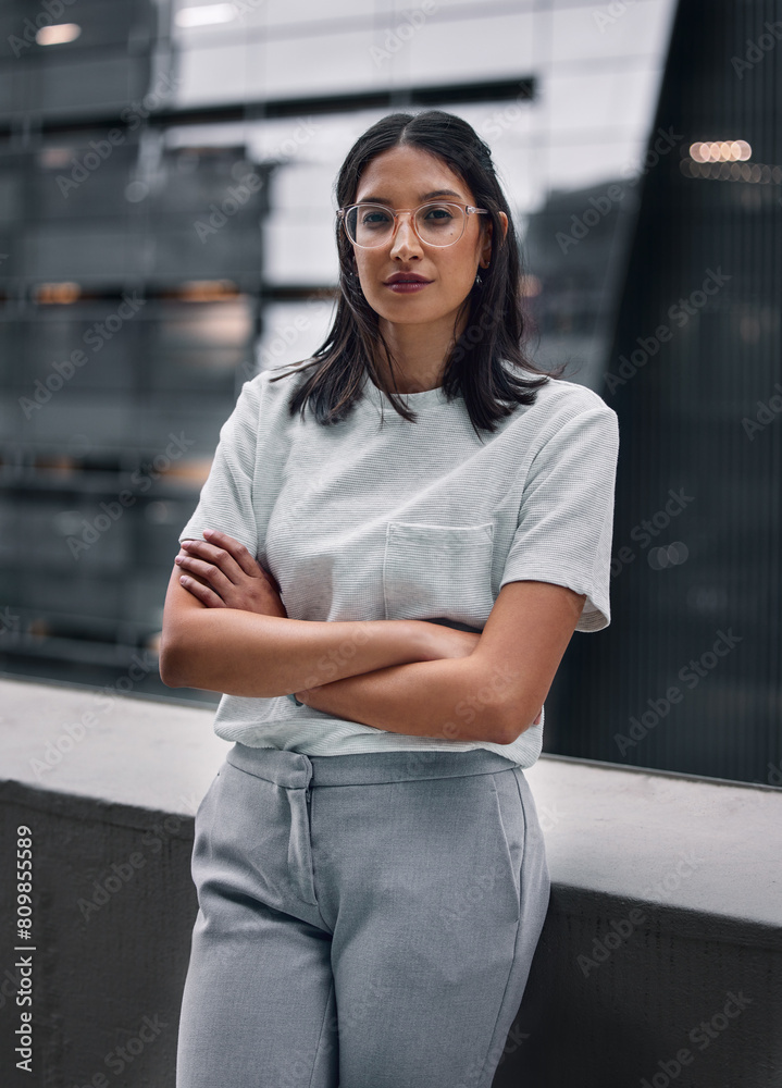 Woman, confident and portrait of worker on balcony at office outdoor in city to relax for break. Employee, glasses and crossed arms in urban town for creative business career as editor or publisher
