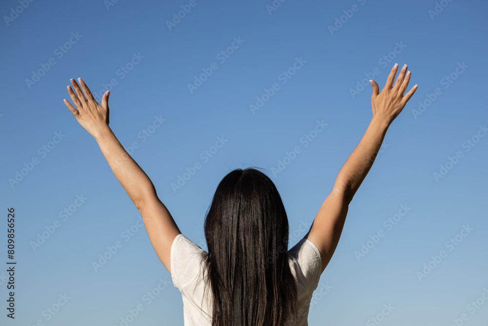 Woman on vacation at a city viewpoint. She is happy to be on vacation in her favorite city. woman with her arms raised celebrating and looking towards infinity. Woman on vacation at a city viewpoint. She is happy to be on vacation in her favorite city. woman with her arms raised celebrating and looking towards infinity.