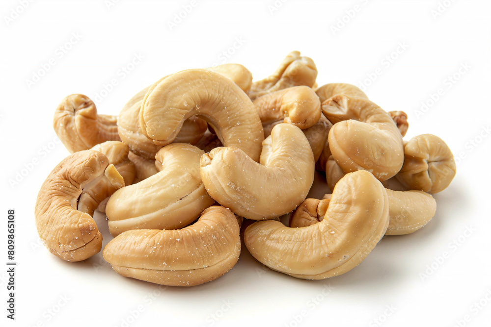 a pile of cashews on a white surface a pile of cashews on a white surface