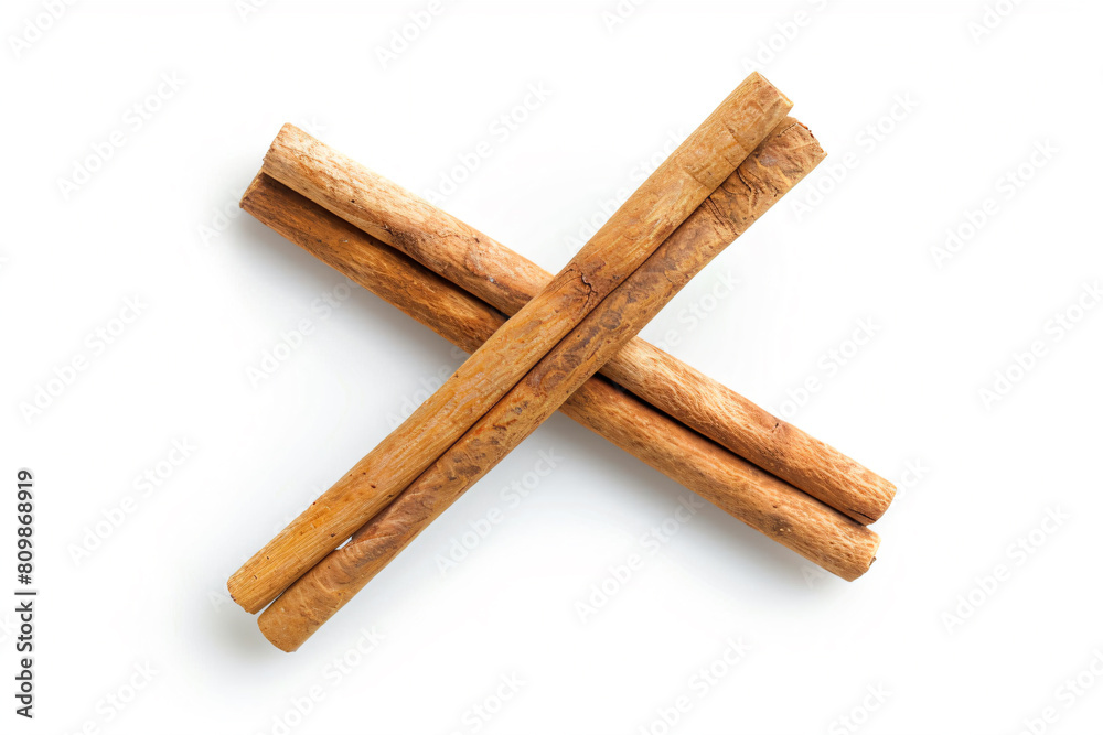 a couple of cinnamon sticks on a white surface a couple of cinnamon sticks on a white surface