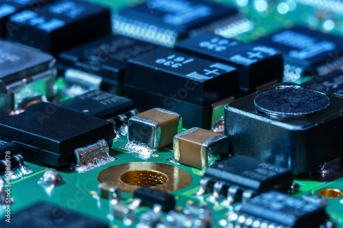 Closeup of Printed Circuit Board with processor, integrated circuits and many other surface mounted passive electrical components.