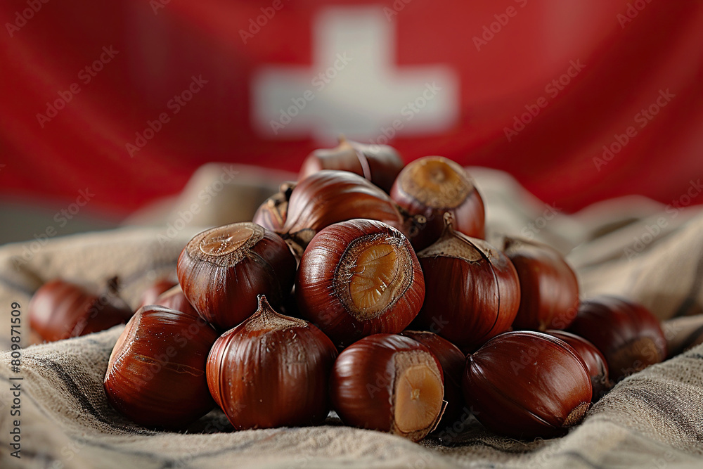 A bunch of chestnuts on burlap against the background of the Swiss flag. Generated by artificial intelligence A bunch of chestnuts on burlap against the background of the Swiss flag. Generated by artificial intelligence