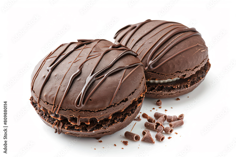 Obraz premium two chocolate macarons with chocolate chips on a white surface