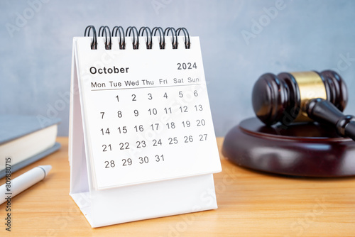 Desk calendar for October 2024 and judge's gavel