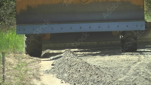 Repair of the road in the middle of the forest with the help of a grader