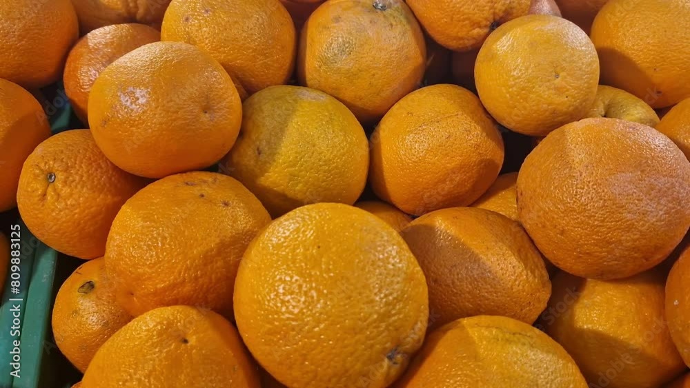 Sale of oranges in the supermarket. Citrus fruits in plastic boxes, close-up with selective focus. Oranges in the store side view. Ripe, juicy, bright orange fruit. Fruit enriched with vitamin C Sale of oranges in the supermarket. Citrus fruits in plastic boxes, close-up with selective focus. Oranges in the store side view. Ripe, juicy, bright orange fruit. Fruit enriched with vitamin C