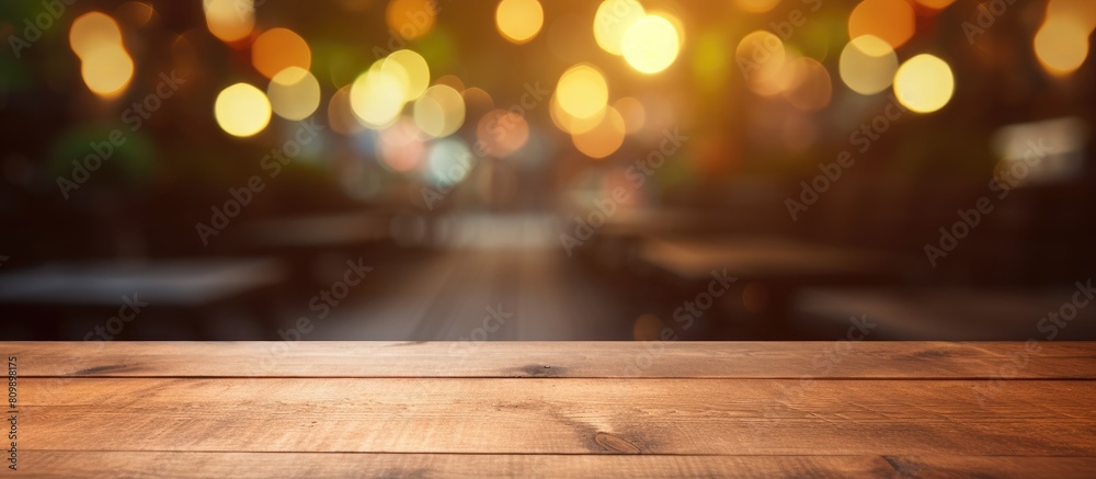 A brown wooden table with an empty surface is placed against a colorful blurred background suitable for showcasing products and creating website banners with copy space image A brown wooden table with an empty surface is placed against a colorful blurred background suitable for showcasing products and creating website banners with copy space image