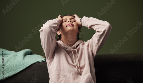 Woman, frustrated and crying on sofa for mental health with anxiety, headache and depression from unemployment crisis. Pain, stress and tired gen z girl in home for heartbreak, sad and breakup © peopleimages.com