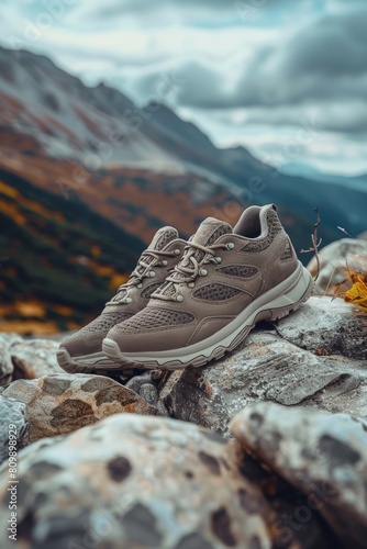 Outdoor sneakers placed on rocks in the mountains