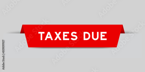 Red color inserted label with word taxed due on gray background