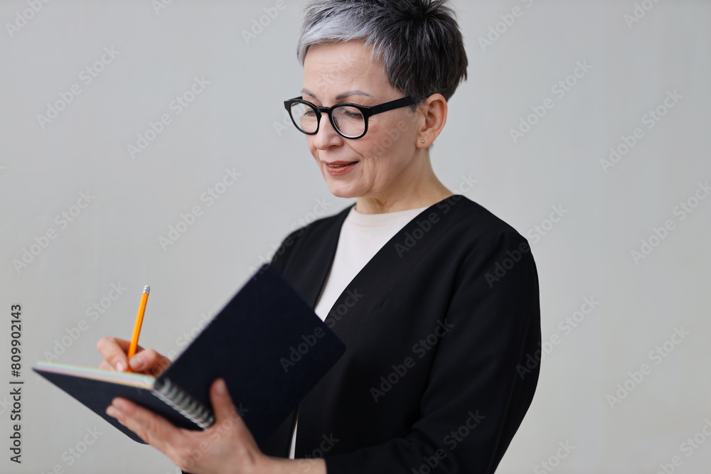 A serious businesswoman reads and thinks about budgeting, embodying wisdom and professionalism. A serious businesswoman reads and thinks about budgeting, embodying wisdom and professionalism.