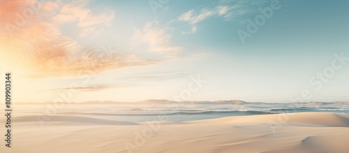 A peaceful and relaxing summer concept of a desert beach at sunset with a white sandy background and ample copy space for your image