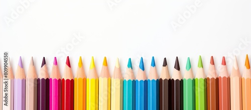 A semicircle arrangement of colored watercolor pencils on a white background perfect for adding text or graphics Copy space image