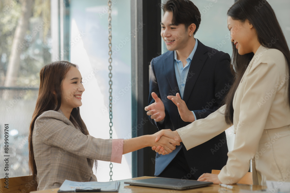 doing handshake in the office to make agreement, two companies are ...