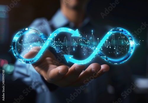 The image shows a person holding a glowing blue infinity symbol in the palm of their hand photo