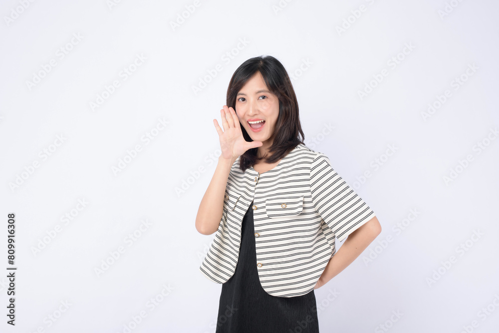 Asian woman is posing with a shouting gesture against a white background. Asian woman is posing with a shouting gesture against a white background.