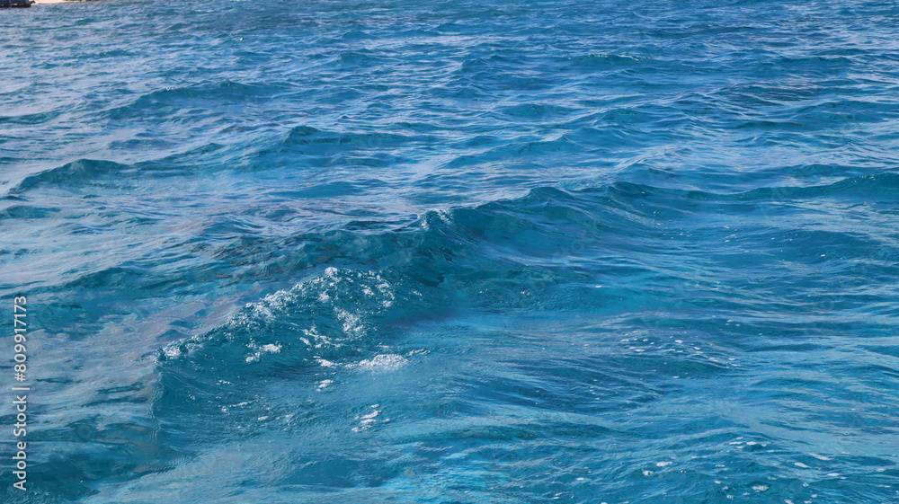 Pristine crystal clear turquoise blue sea water of th Caribbean Atlantic ocean flowing with waves Pristine crystal clear turquoise blue sea water of th Caribbean Atlantic ocean flowing with waves
