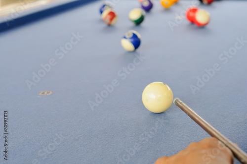 the hand of a man playing billiards