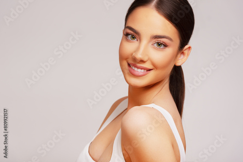 Beautiful woman on bright gray background. Beauty portrait. 