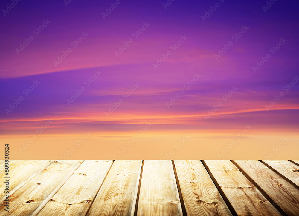 Wooden table on sky background and sunset light Wooden table on sky background and sunset light