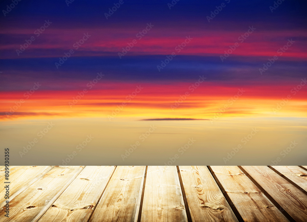 Wooden table on sky background and sunset light Wooden table on sky background and sunset light