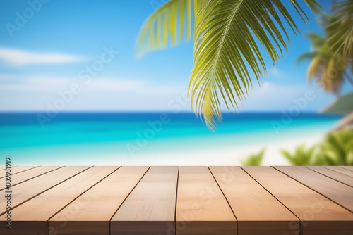 Top of wood table with seascape and palm leaves, blur bokeh light of calm sea and sky at tropical beach background. Empty ready for your product display montage. summer vacation background concept.