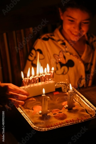 High resolution image of an eleven year old girl blowing her birthday candles on a cake- Israel