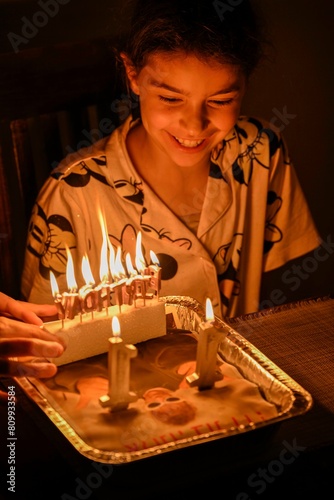 High resolution image of an eleven year old girl blowing her birthday candles on a cake- Israel