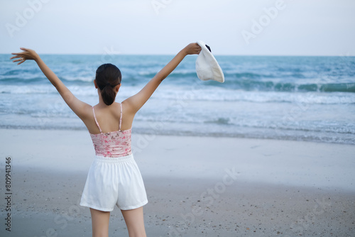 young asia woman stand resting on tropical Beach, travel the sea