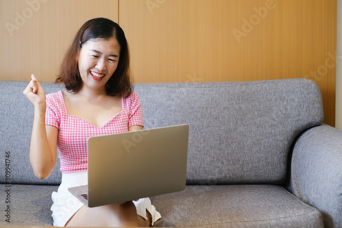 Asia woman playing or working with laptop, work form home