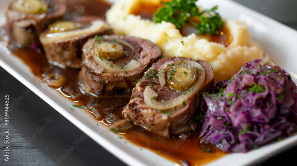 Exquisite beef rolls tied with twine, served with creamy mashed potatoes and braised red cabbage on a modern white plate Exquisite beef rolls tied with twine, served with creamy mashed potatoes and braised red cabbage on a modern white plate