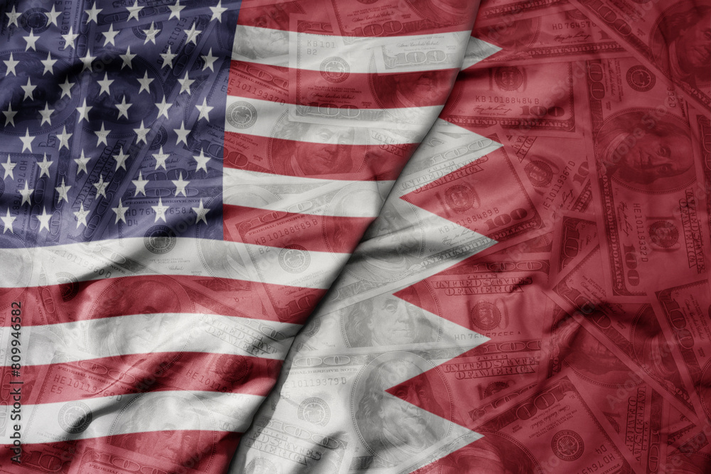 big waving colorful flag of united states of america and national flag of bahrain on the dollar money background. finance concept. big waving colorful flag of united states of america and national flag of bahrain on the dollar money background. finance concept.