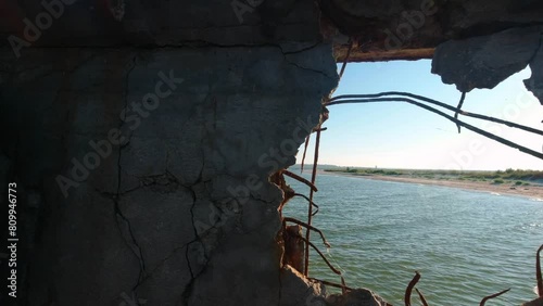 View of the Kinburn Spit through a hole in the side of an old abandoned barge that ran aground on the edge of the spit. photo