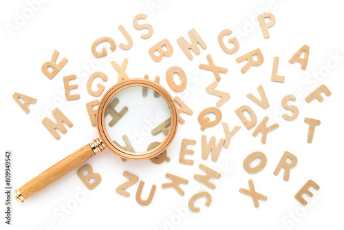 Magnifying glass and scattered English alphabets isolated on white background, glossary, find the right word to communicate, English learning