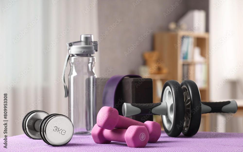 Many different sports equipment on mat indoors Many different sports equipment on mat indoors