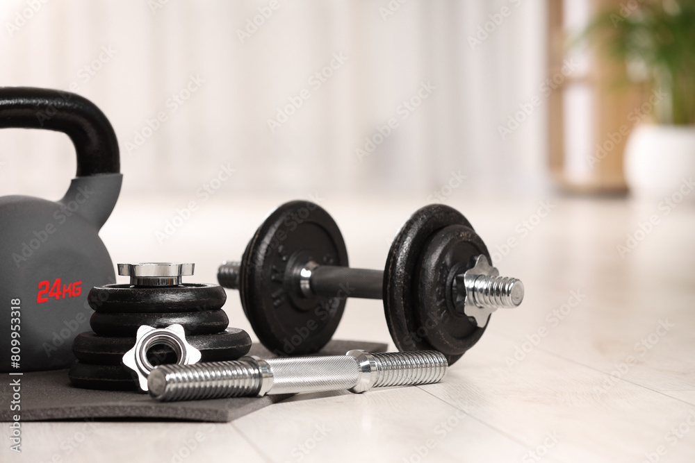 Many different sports equipment on floor indoors Many different sports equipment on floor indoors