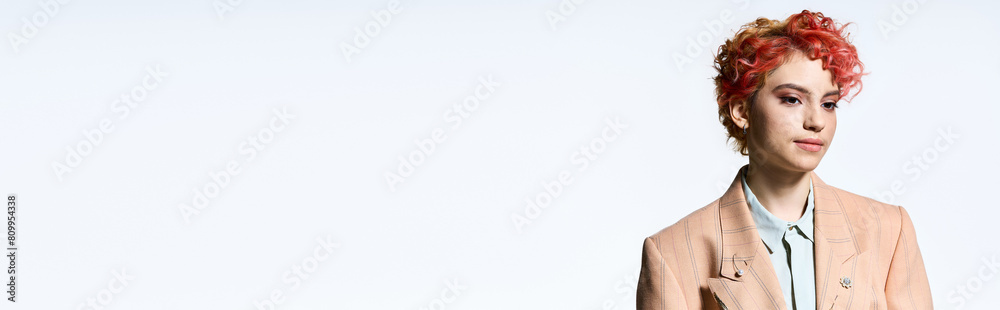 A striking red-haired woman exudes confidence in a stylish suit and tie. A striking red-haired woman exudes confidence in a stylish suit and tie.