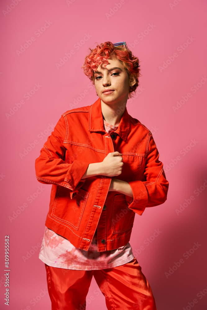 A woman stands out in a bold red jacket and red pants. A woman stands out in a bold red jacket and red pants.