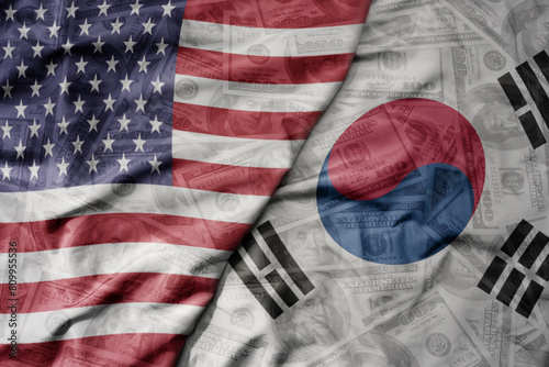 big waving colorful flag of united states of america and national flag of south korea on the dollar money background. finance concept. photo